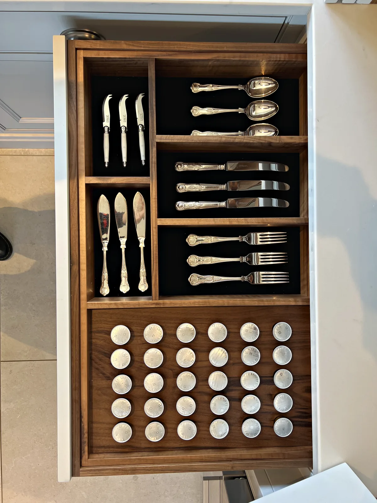Walnut cutlery drawer insert with fitted slots for cutlery and round holes for spice jars