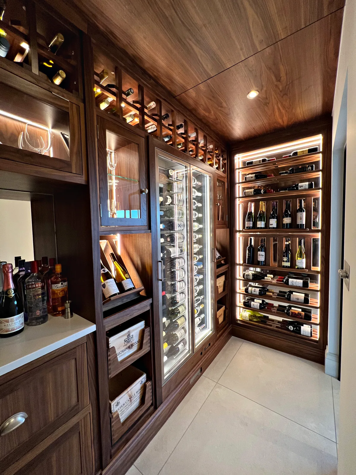 Walk in wine room in American black walnut with lit bottle racks
