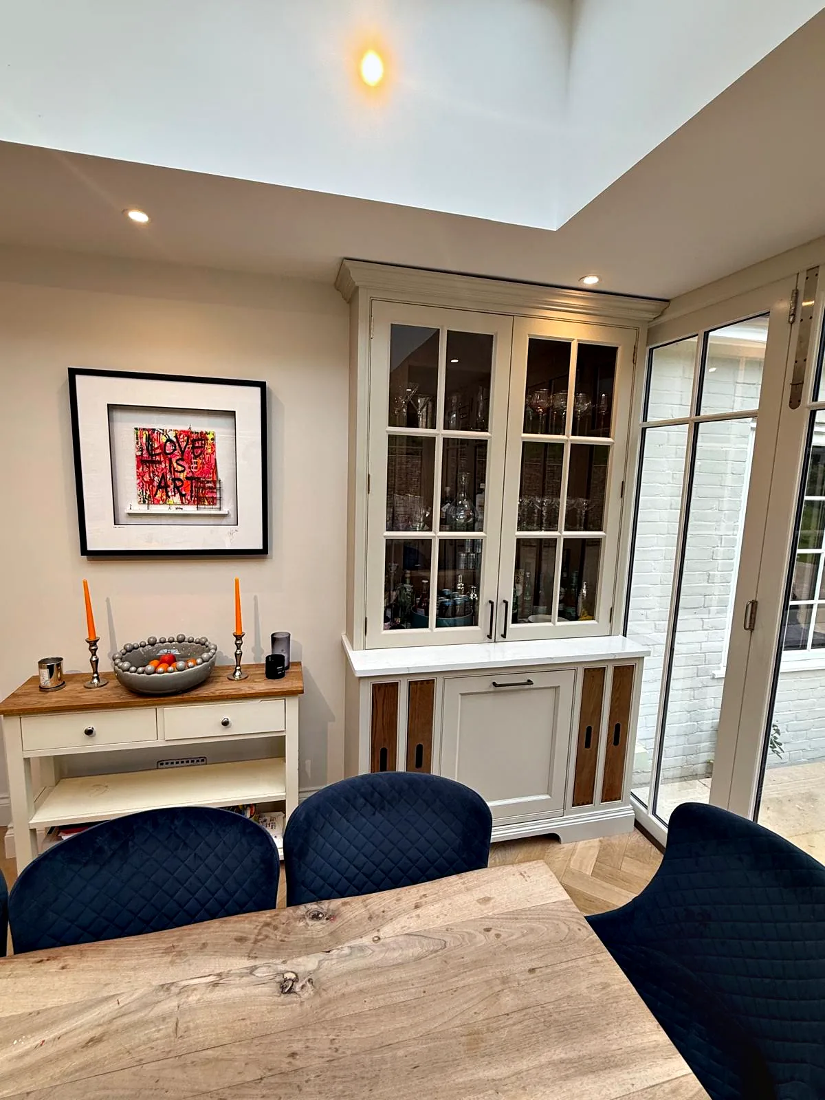 Glazed dresser with oak inset panels beyond the dining table