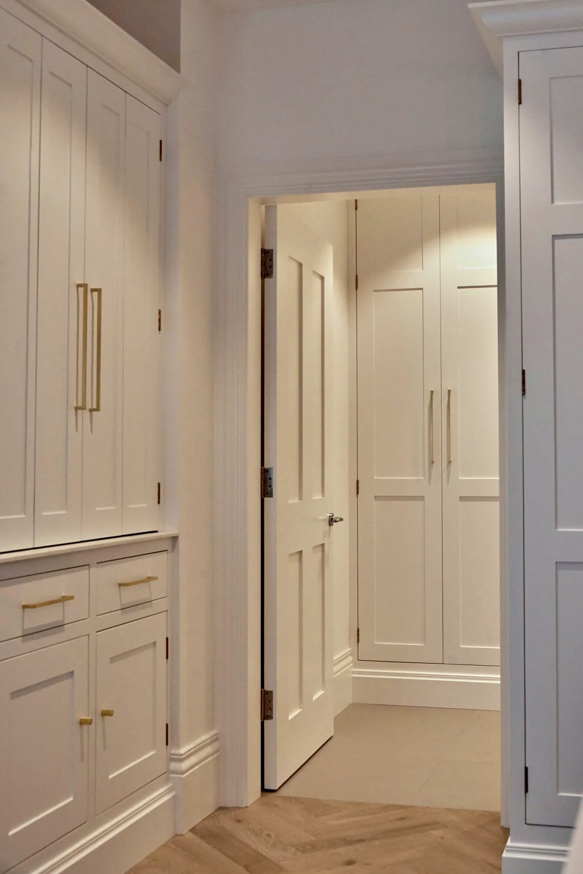 Tall painted cupboards running into the hallway