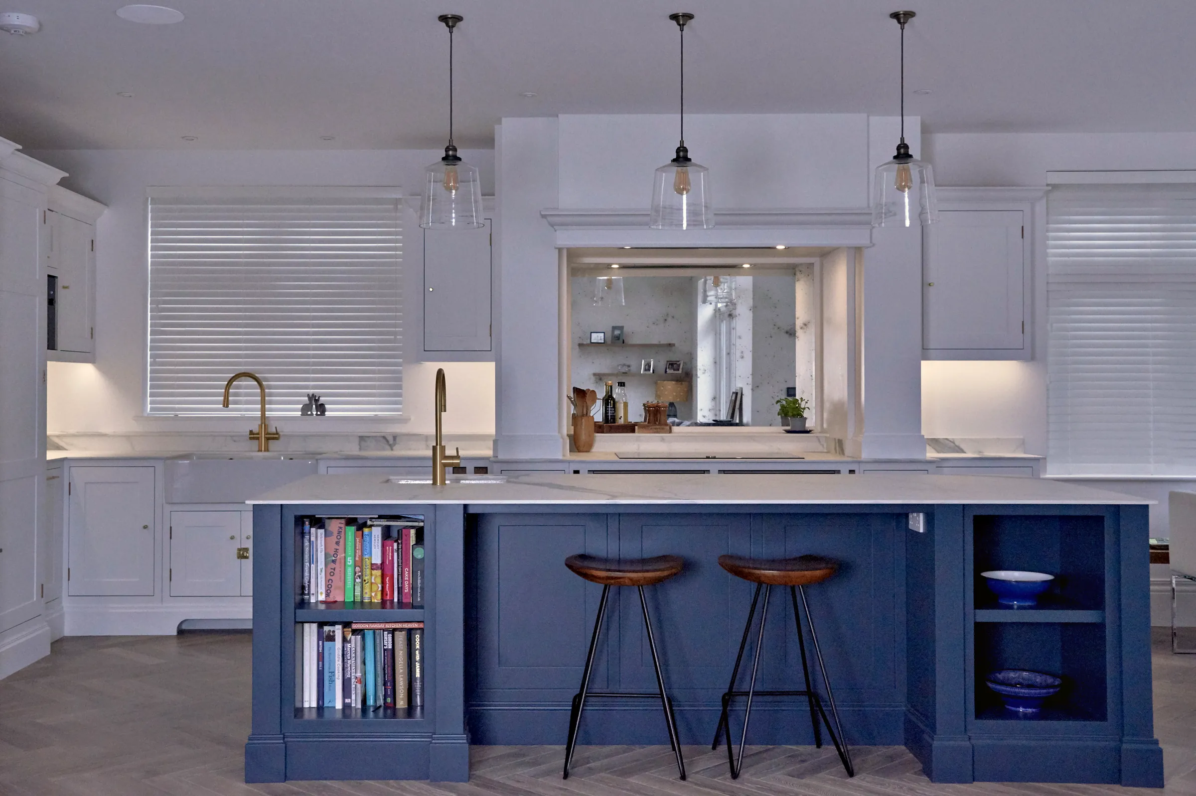 Malbrook kitchen in All White with a Hague Blue island, bookshelves and leather stools