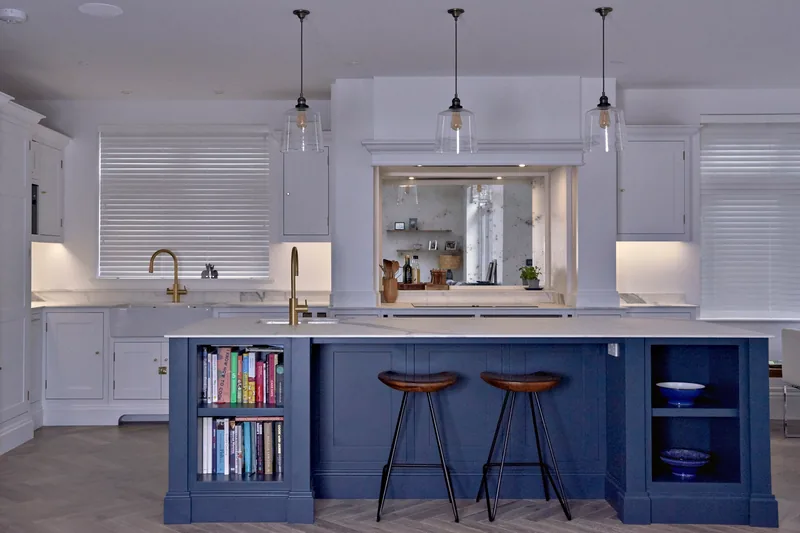 Malbrook kitchen in All White with a Hague Blue island, bookshelves and leather stools