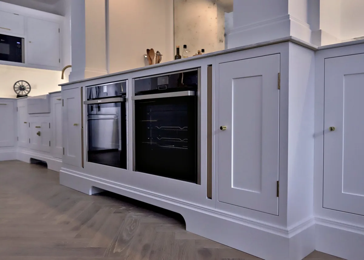 Built in ovens in All White cabinetry with a profiled plinth