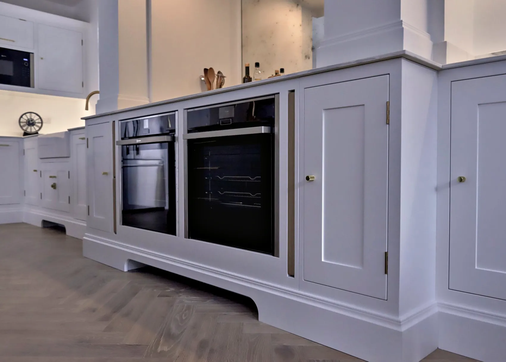 Built in ovens in All White cabinetry with a profiled plinth