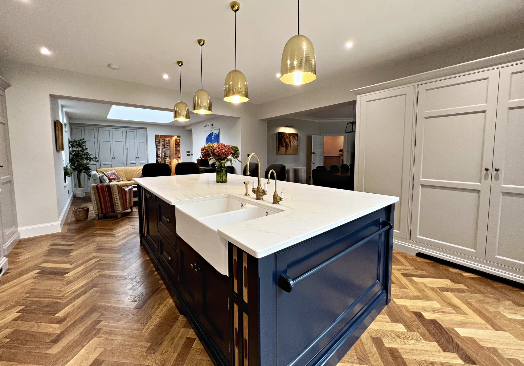 Butler sink set into the island with antique brass Withenshaw handles