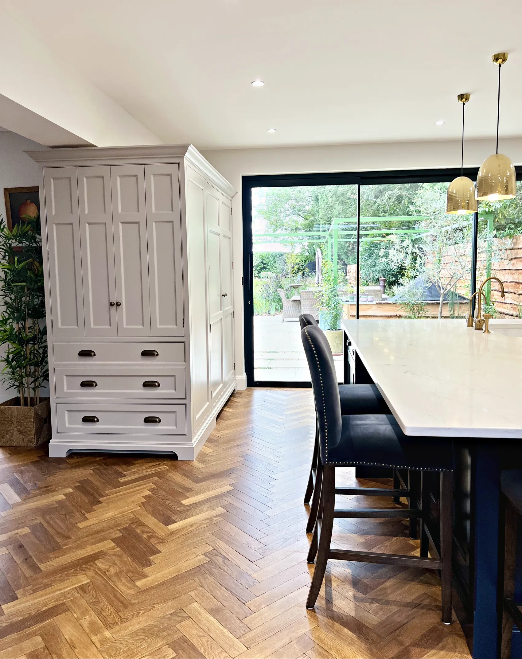 Larder cupboard beside the island and the garden doors