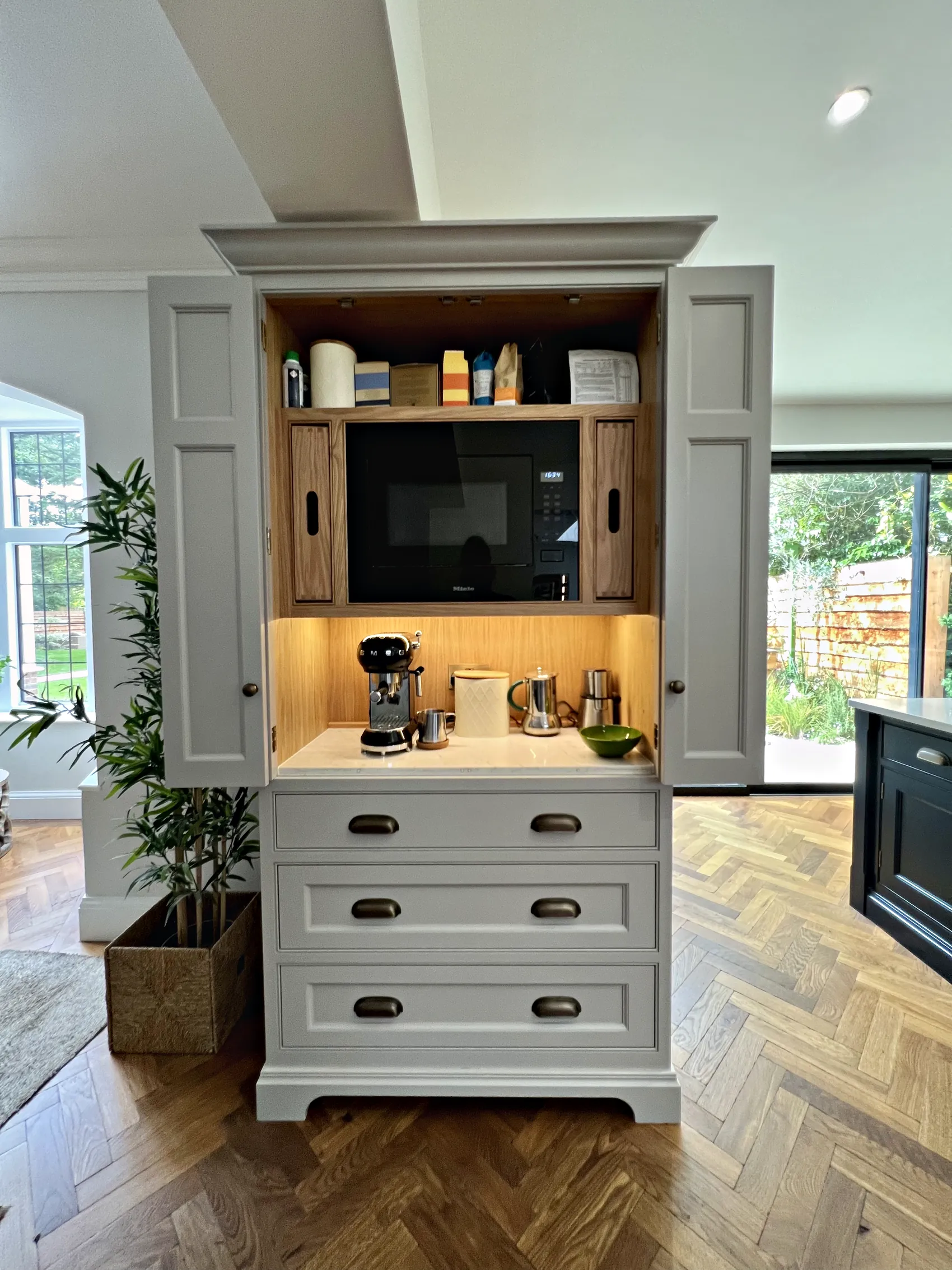 Drinks preparation larder with a coffee machine and an oak interior