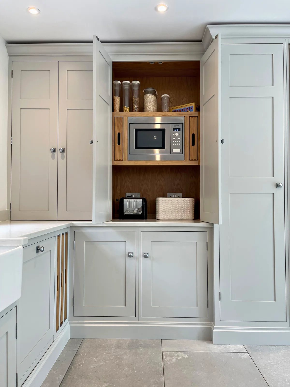 Breakfast larder with an oak interior and a built in microwave