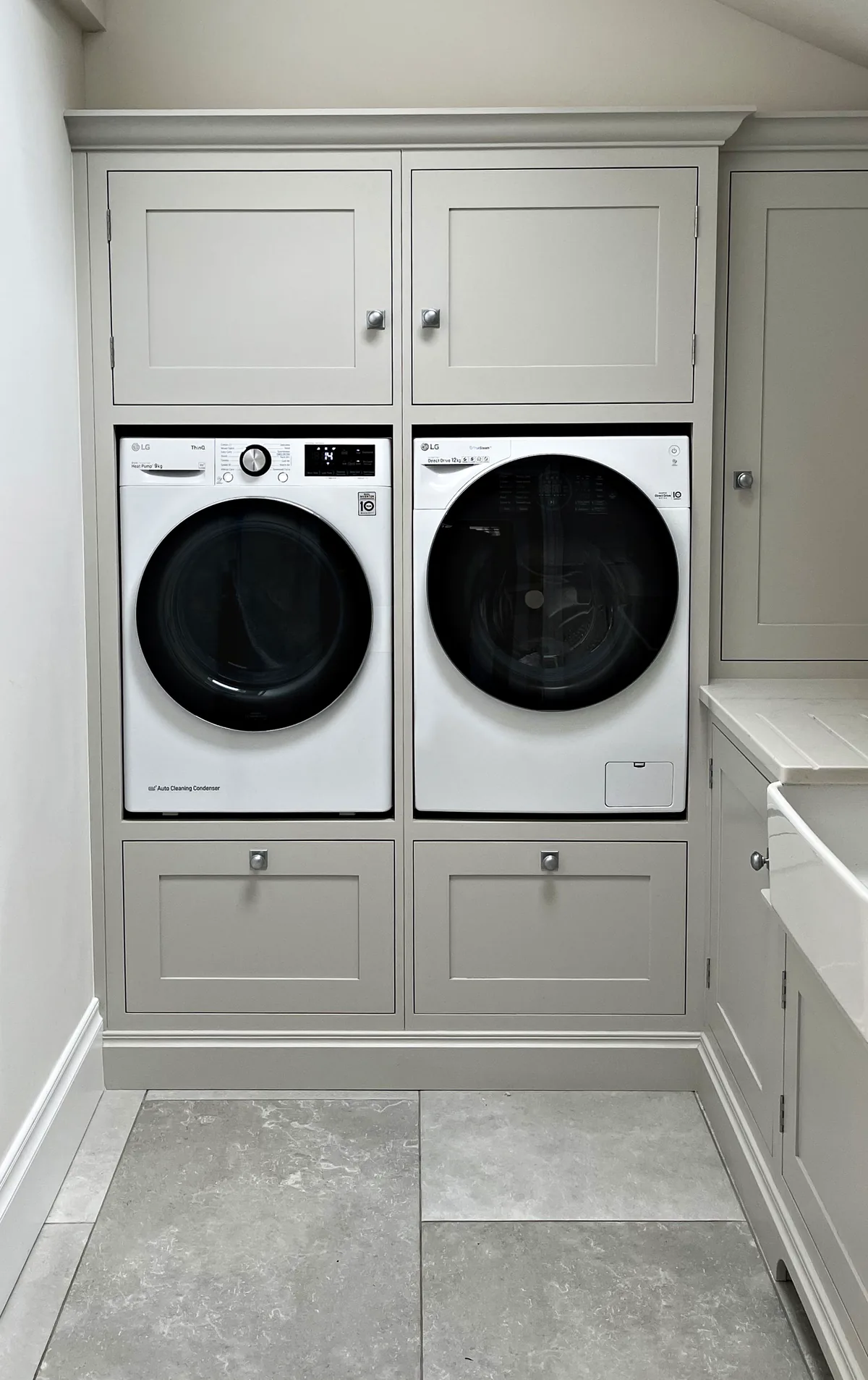 Laundry room with stacked appliances in painted cabinetry