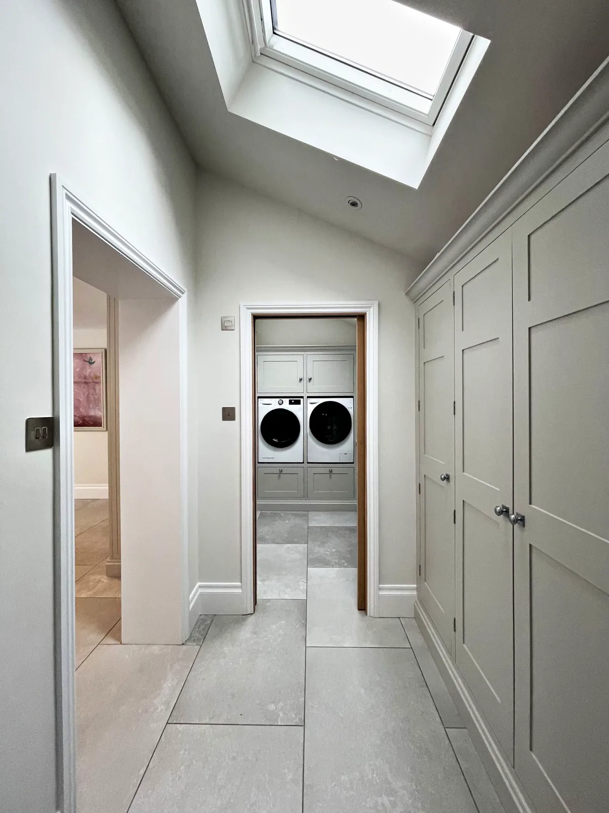 Floor to ceiling fitted cupboards along a corridor