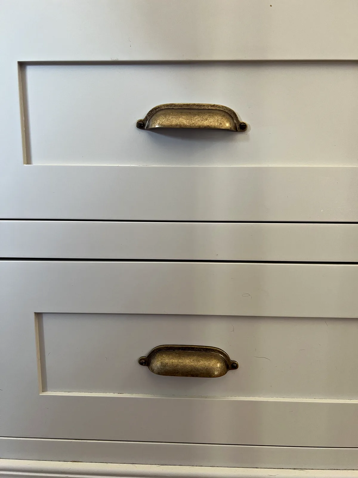 Stack of cream drawers with antique brass cup handles