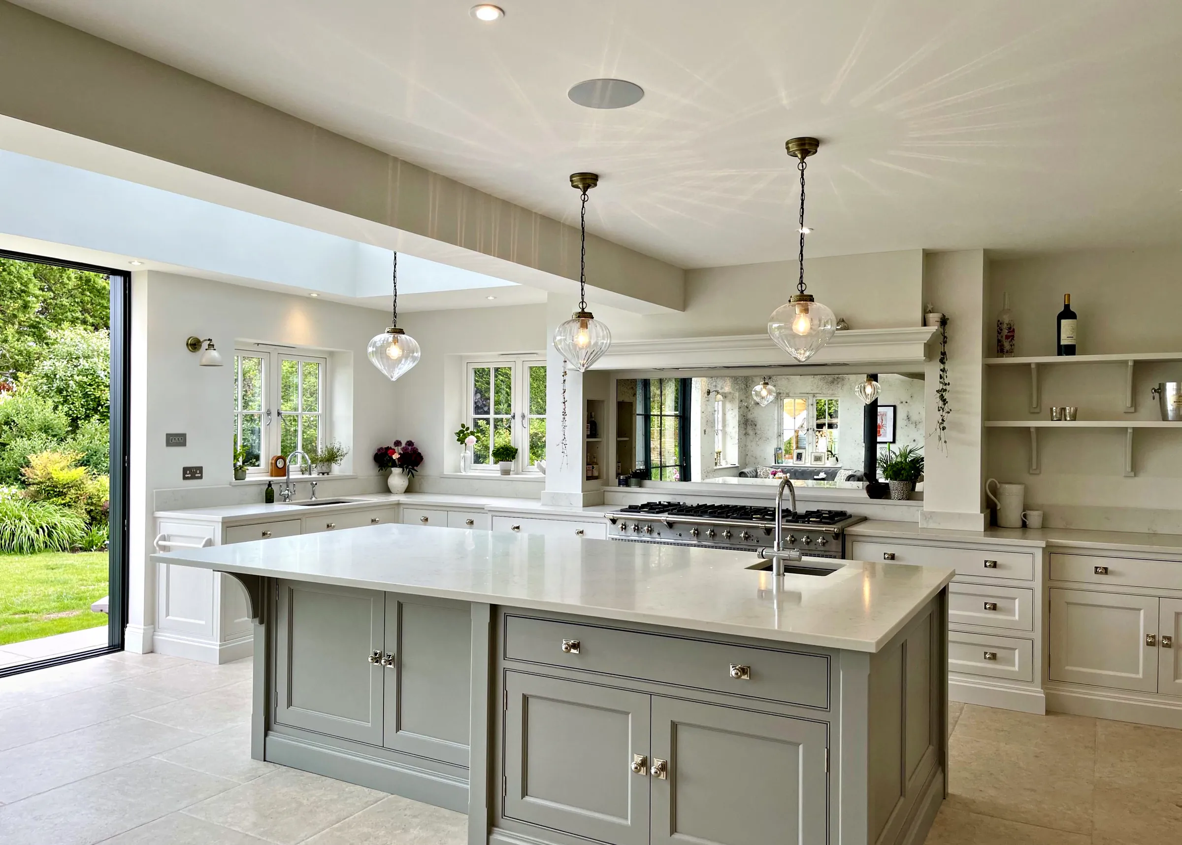 Wrens Hill kitchen in Ammonite with a Worsted island and the garden doors open