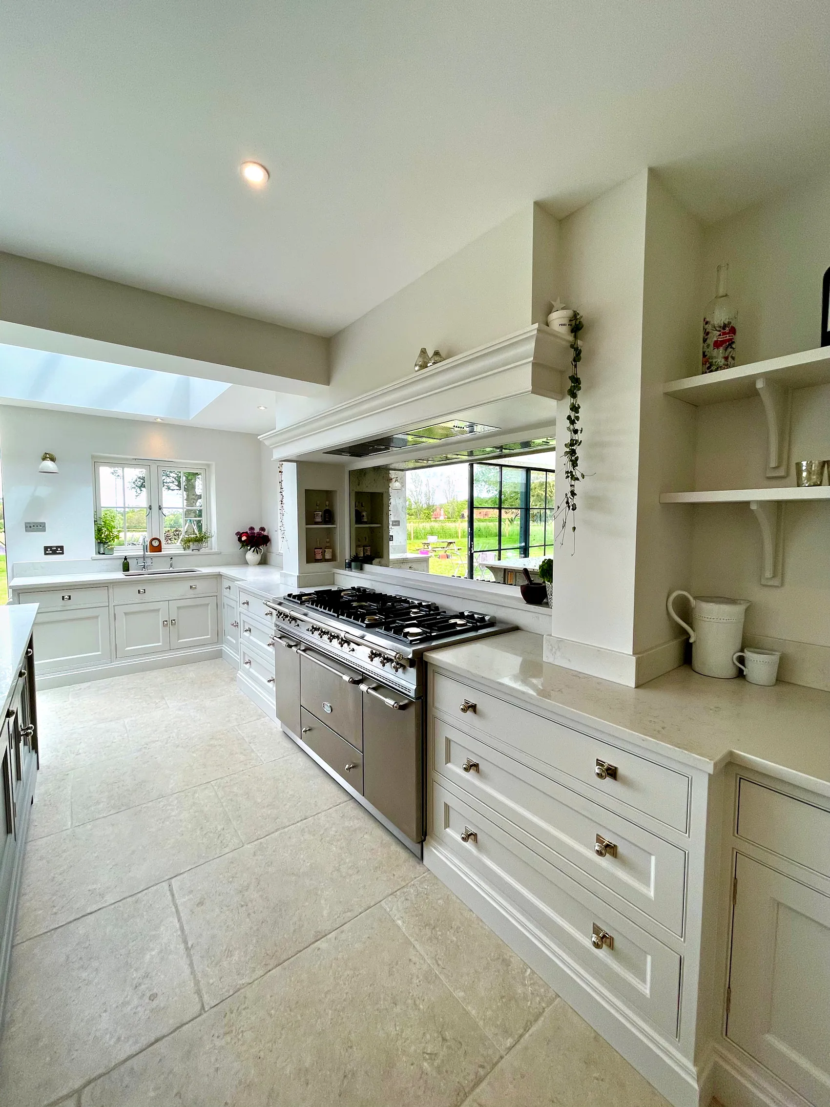 Mirrored splashback behind the range with open shelves