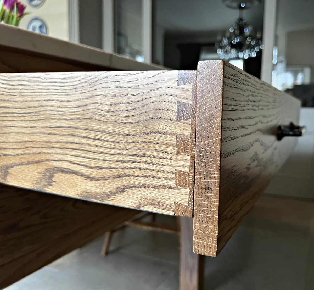 Hand cut dovetails on an oak drawer in a table island