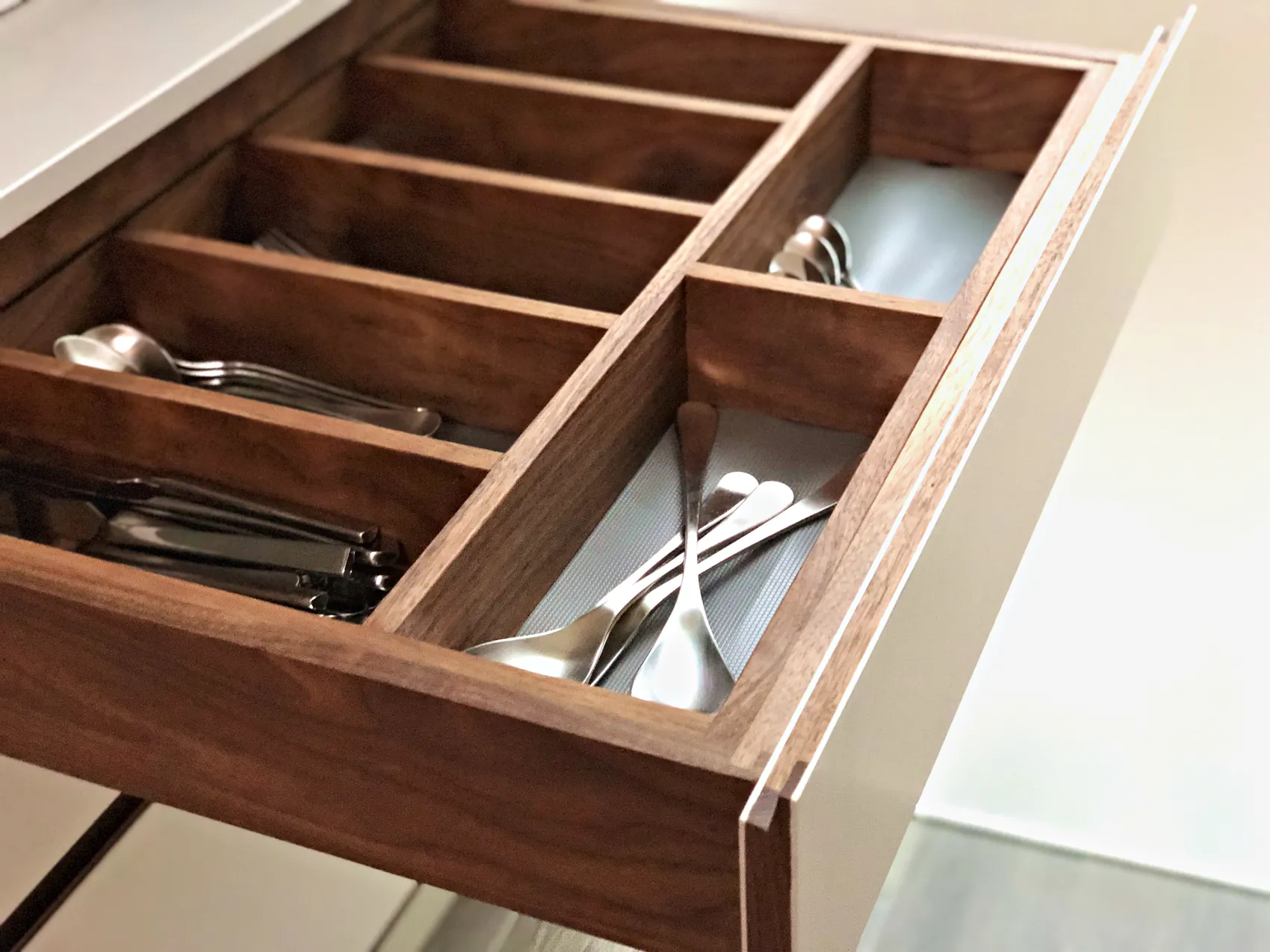 Walnut cutlery drawer insert holding cutlery